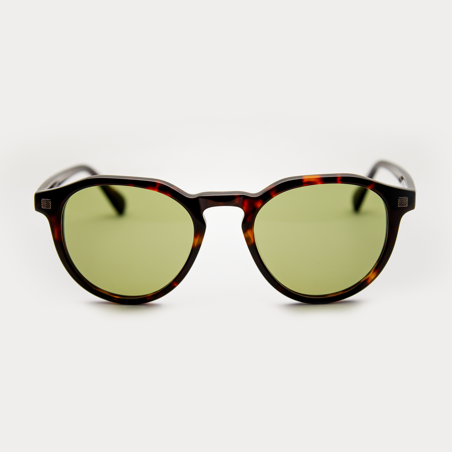 Adam Young Eyewear markalı güneş gözlüğü, yeşil camlı tortoiseshell çerçeve ile şık bir görünüm sunuyor.